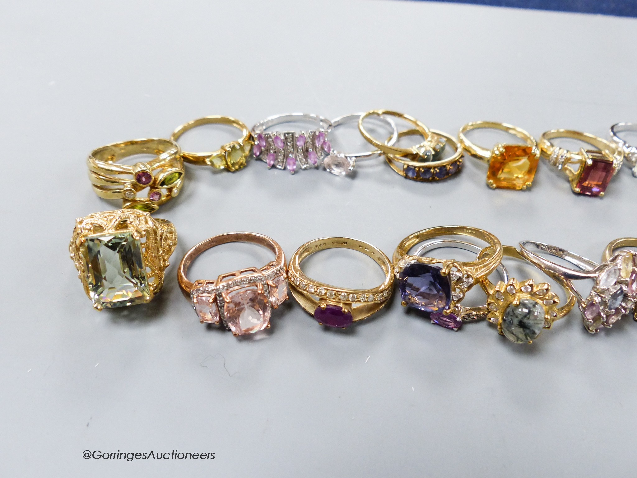 Twenty assorted modern 9ct or 9k and gem set dress rings, gross 65.5 grams.